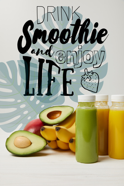fresh detox fruits and smoothies in bottles on white background, drink smoothie and enjoy life inscription - Photo, Image