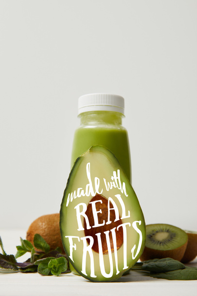 green detox smoothie with avocado, kiwi and mint on white wooden surface, made with real fruits inscription - Photo, Image