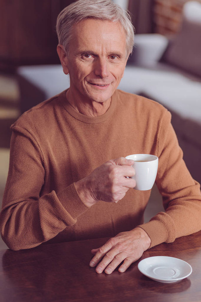 Portrait of delighted retirement that drinking coffee - Fotografie, Obrázek