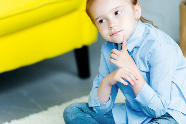 cropped shot of pensive little child looking away at home - Foto, imagen