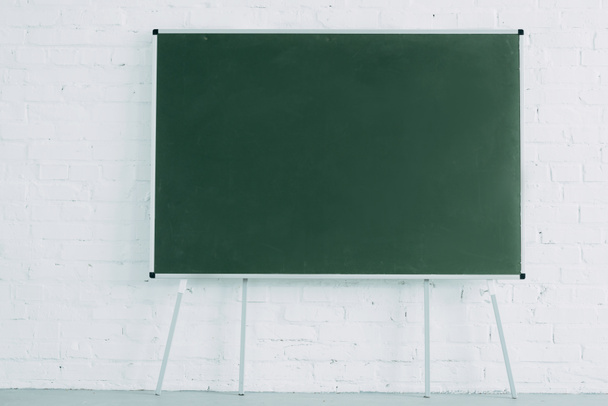 blank blackboard and white brick wall - Photo, Image