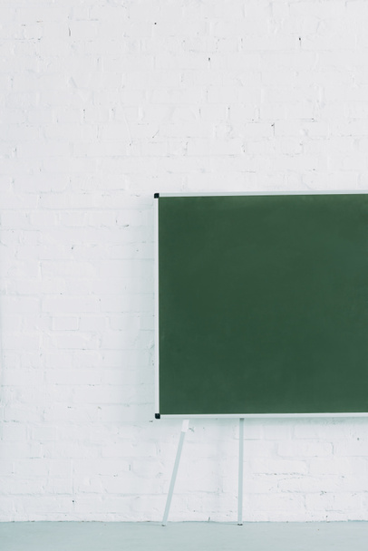 blank chalkboard and white brick wall - Фото, зображення