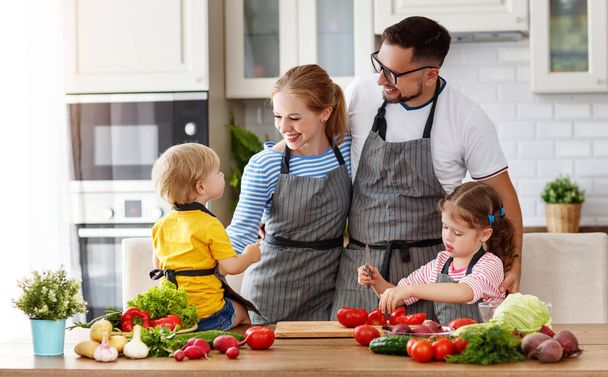 heureux famille avec enfant préparation salade de légumes à hom
 - Photo, image