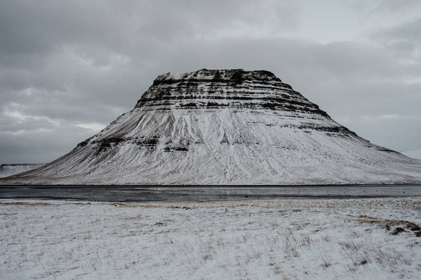 A view onto Kirkjufell, Iceland in the middle of winter with lots of snow. - Fotó, kép