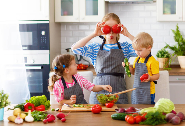 mother with children preparing vegetable salad at home - Fotografie, Obrázek