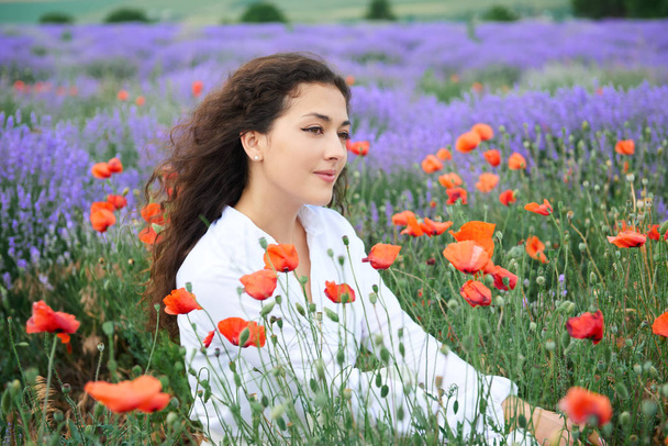 young girl portrait is in the lavender field, beautiful summer landscape with flowers - Photo, Image