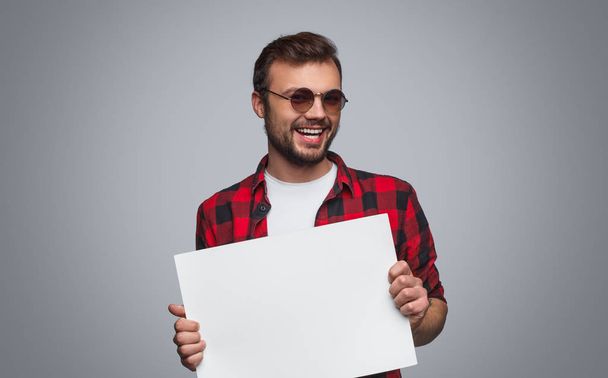Playful hipster man with empty placard - Фото, зображення