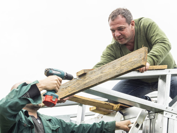 Caucasian man performs roofing wor - Фото, зображення