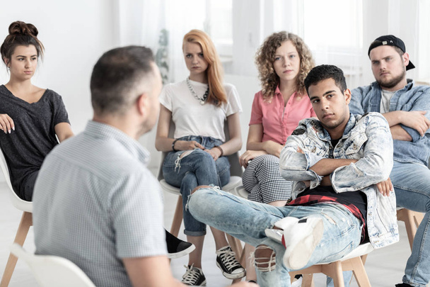 Rebellious teenage man during therapy for difficult youth - Foto, Bild