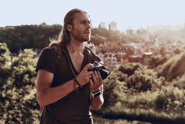 handsome photographer man with camera outdoors  - Valokuva, kuva