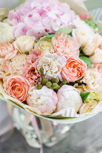 beautiful spring bouquet. flower arrangement with hydrangea and peonies. Color light pink. The concept of a flower shop, a small family business - Photo, Image