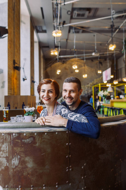 Young couple sitting in loft cafe - Foto, imagen