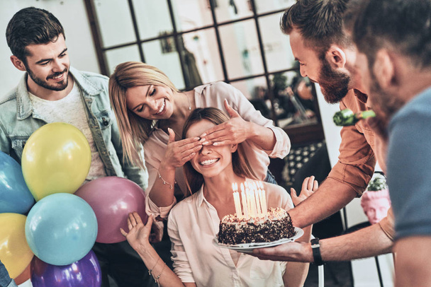 happy people celebrating birthday, smiling woman with covered eyes waiting for cake  - Фото, зображення