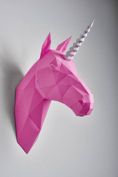 Pink saturated geometrical unicorns head. - Zdjęcie, obraz