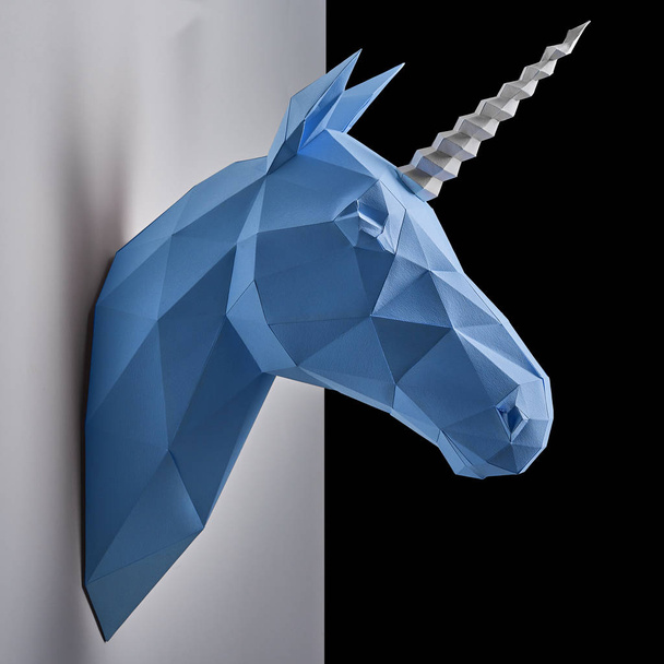 blue unicorns head hanging on grey shadowed wall. - Fotografie, Obrázek