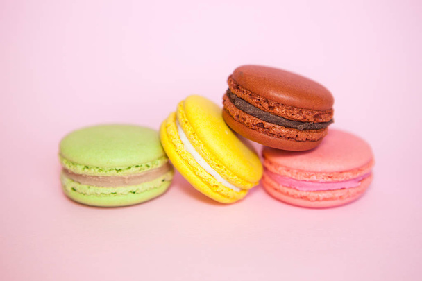 Macaroon biscuits on pastel pink background, beautiful sweet food - Fotoğraf, Görsel