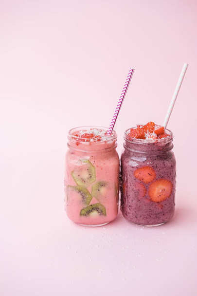 Berry smoothies with strawberries and blueberries in a glass jar on a gray background - Photo, Image