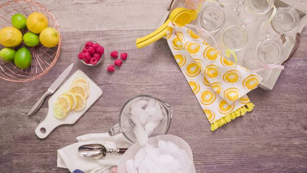 Step by step. Preparing raspberry lemonade with fresh lemons and raspberries in drinking mason jars. - Photo, Image