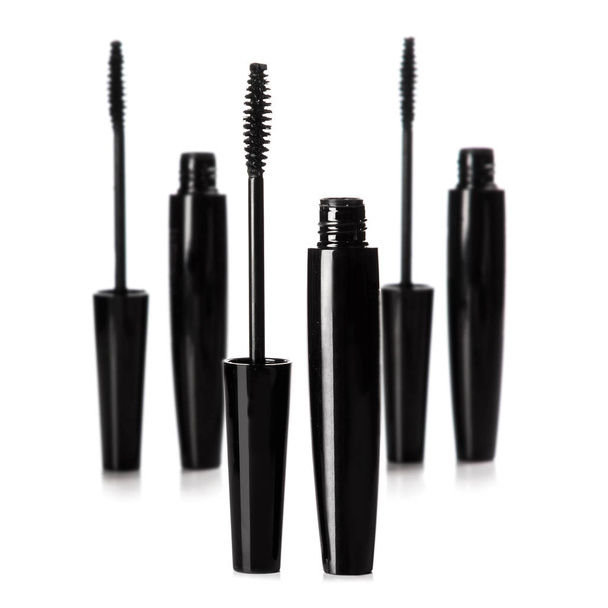 Mascara brushes and containers on white background - Photo, image
