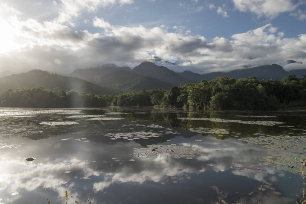 Beautiful lake with mountains and wild natural landscape, Atlantic Rainforest ecological reserve in the countryside of Rio de Janeiro near Guapiacu, Brazil - Photo, image