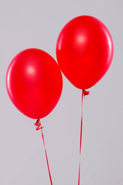 Two colorful balloons isolated on gray background - Photo, image