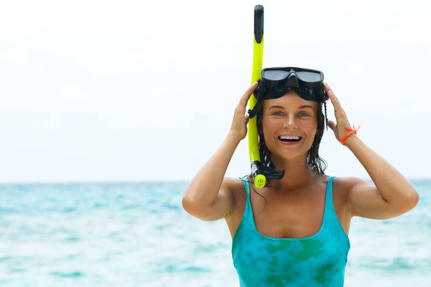 Happy beautiful woman on beach with mask for snorkeling - Zdjęcie, obraz