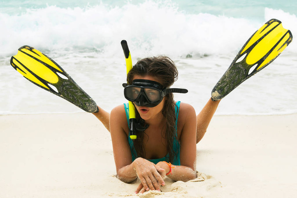 Beautiful woman with mask and flippers for snorkeling on beach - Fotó, kép