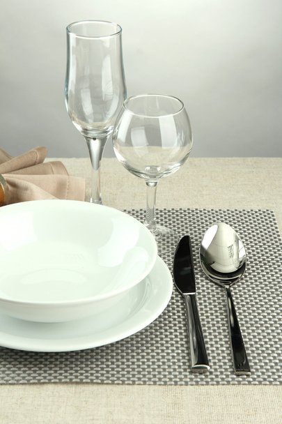 Table setting, on grey background - Φωτογραφία, εικόνα