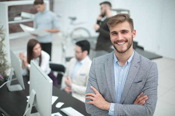smiling young businessman in the background of the office - Zdjęcie, obraz
