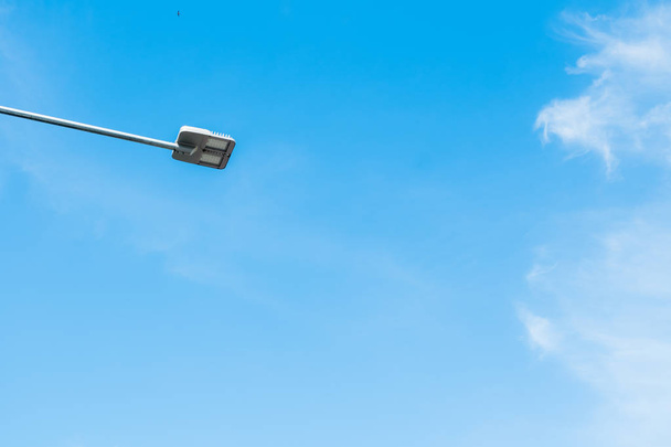 Street light pole in blue sky background. - Фото, зображення