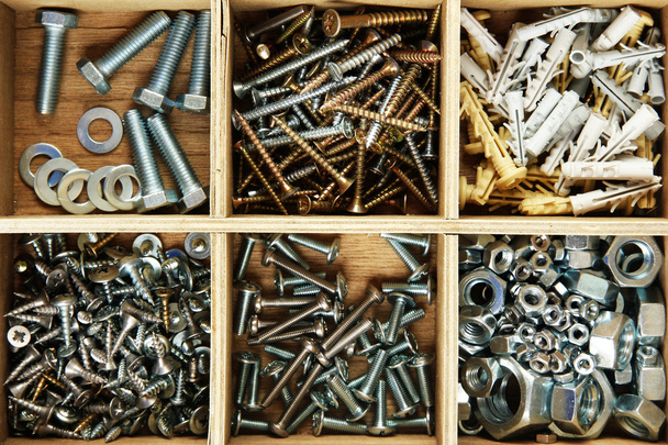 Wooden box for metal bolts, screws and nuts close up - Photo, Image