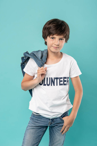 Happy young volunteer holding his jacket - Valokuva, kuva