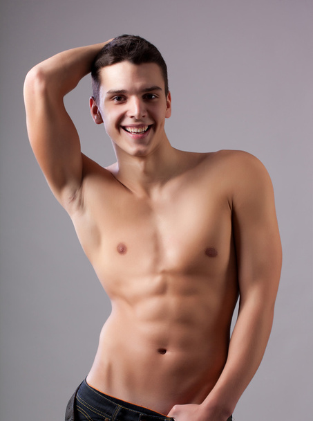 Muscular young sexy nude man on studio - Foto, Imagen