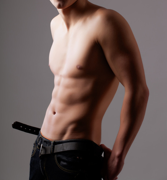 Muscular young sexy nude man on studio - Фото, зображення