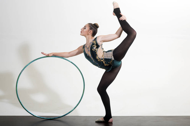 flexible woman in sport pose with hula hoop. flexible body of athlete woman with gymnastic ring. - Photo, Image