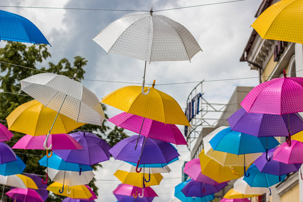 colorful white yellow pink purple and blue umbrellas decoration on urban street environment space outdoor concept - Фото, изображение