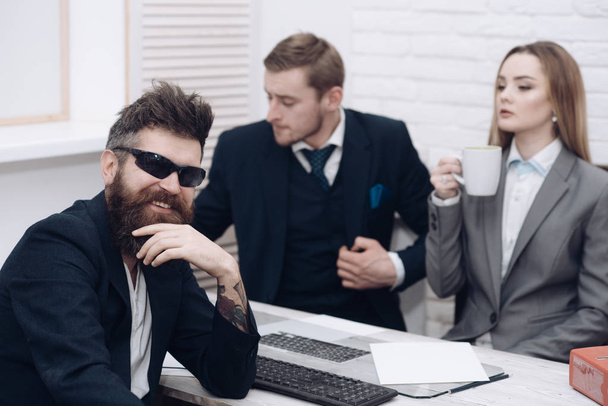 Business partners or businessman at meeting, office background. Business negotiations, discuss conditions of deal. Man with beard and glasses proposes extraordinary startup idea. Startup concept - Zdjęcie, obraz