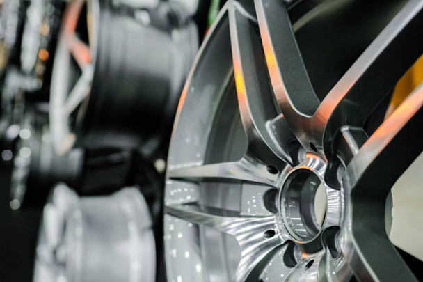 Close up of rims from a sports car. The concept of tuning the wheels of a car. Car wheel. - Photo, Image