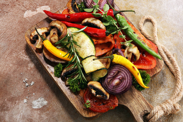 Grilled vegetables. Tomatoes, zucchini, bell pepper and fresh herbs. Vegan grill concept. - Фото, изображение