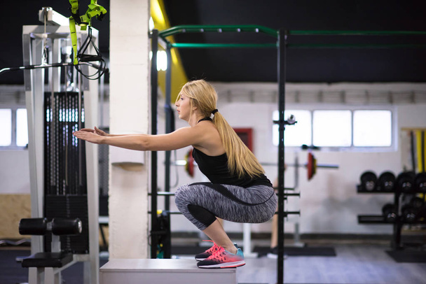 young athletic woman training  jumping on fit box at cross fitness gym - Photo, Image