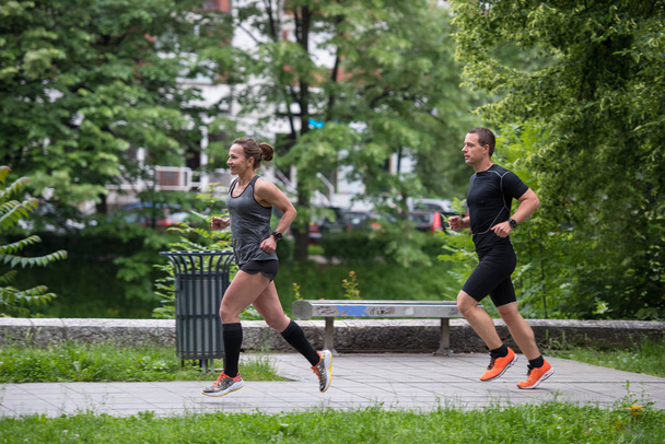 group of healthy people jogging in city park, runners team on morning training - Fotoğraf, Görsel