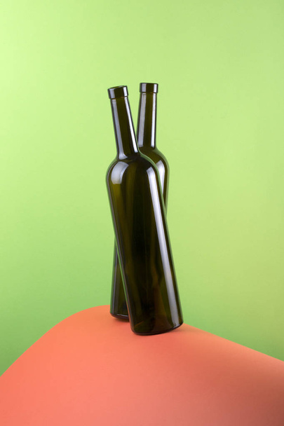 Abstract still life with color background and two glass bottles - Foto, imagen