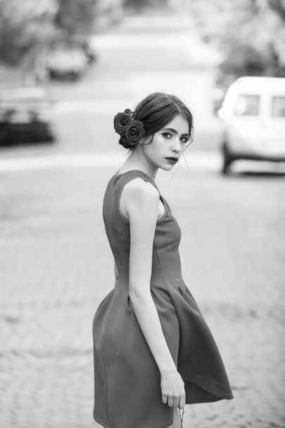 Caucasian female fashion model posing. Pretty girl in stylish, red dress walking on road - Foto, immagini