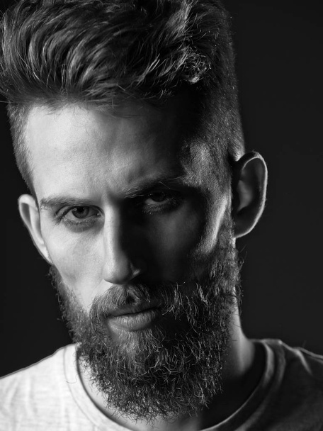 Caring for the beard. man, bearded young hipster has mustache on serious face - Foto, immagini