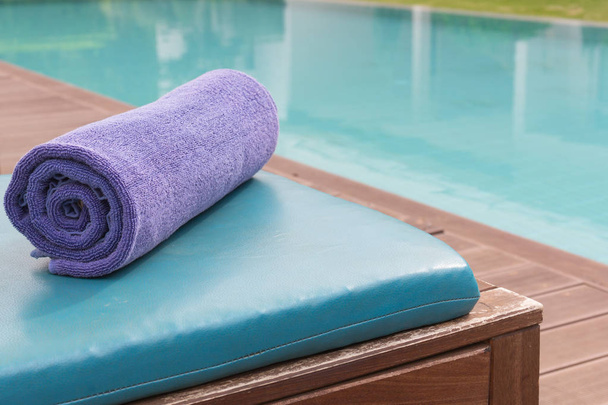 New purple towel on bed pool at the swimming pool. - Photo, Image