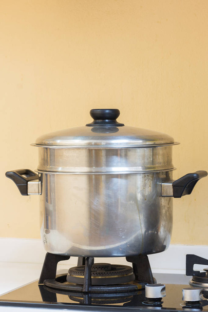 Big hot pot set on gas stove in modern kitchen. - Foto, immagini
