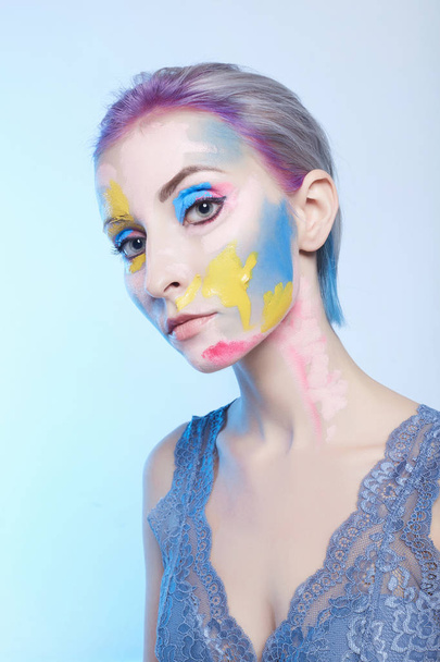 young woman with paint on her face. painted mask girl.halloween body art - Φωτογραφία, εικόνα