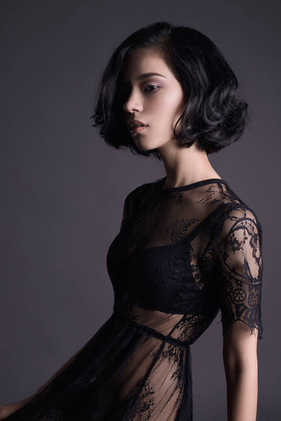beautiful young woman in black sexy dress sitting on stool.sexual beauty brunette girl - Valokuva, kuva