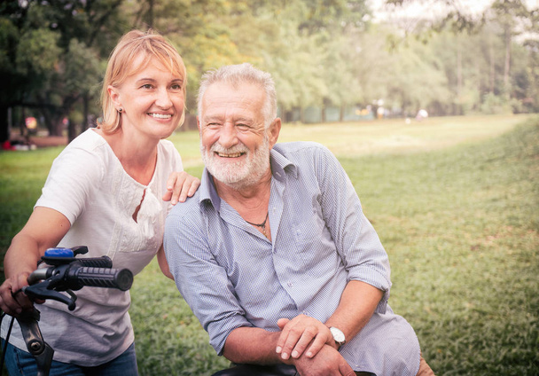 Senior couple in love relaxing in the park - Photo, Image