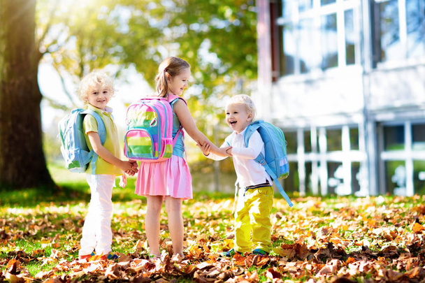 Children go back to school. Start of new school year after summer vacation. Boy and girl with backpack and books on first school day. Beginning of class. Education for kindergarten and preschool kids. - Photo, Image